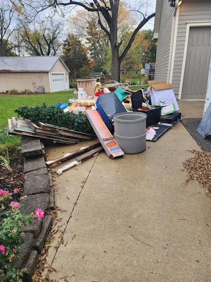 Dumpster being loaded with debris for Residential Dumpster Rental in Hampton